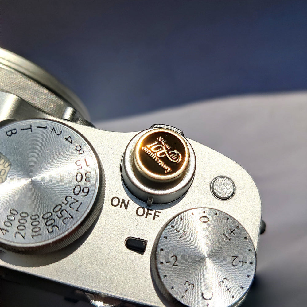 100th Nikon Camera shutter button gold