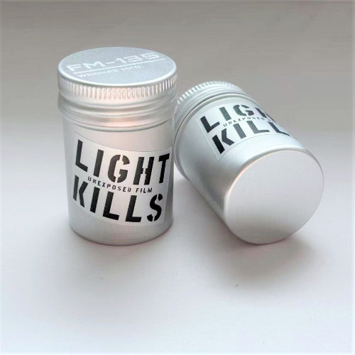 Two metal film containers with 'Light Kills' text on a white background