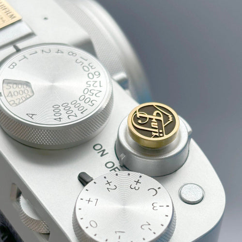 Custom brass camera shutter button designed for Fujifilm X-series