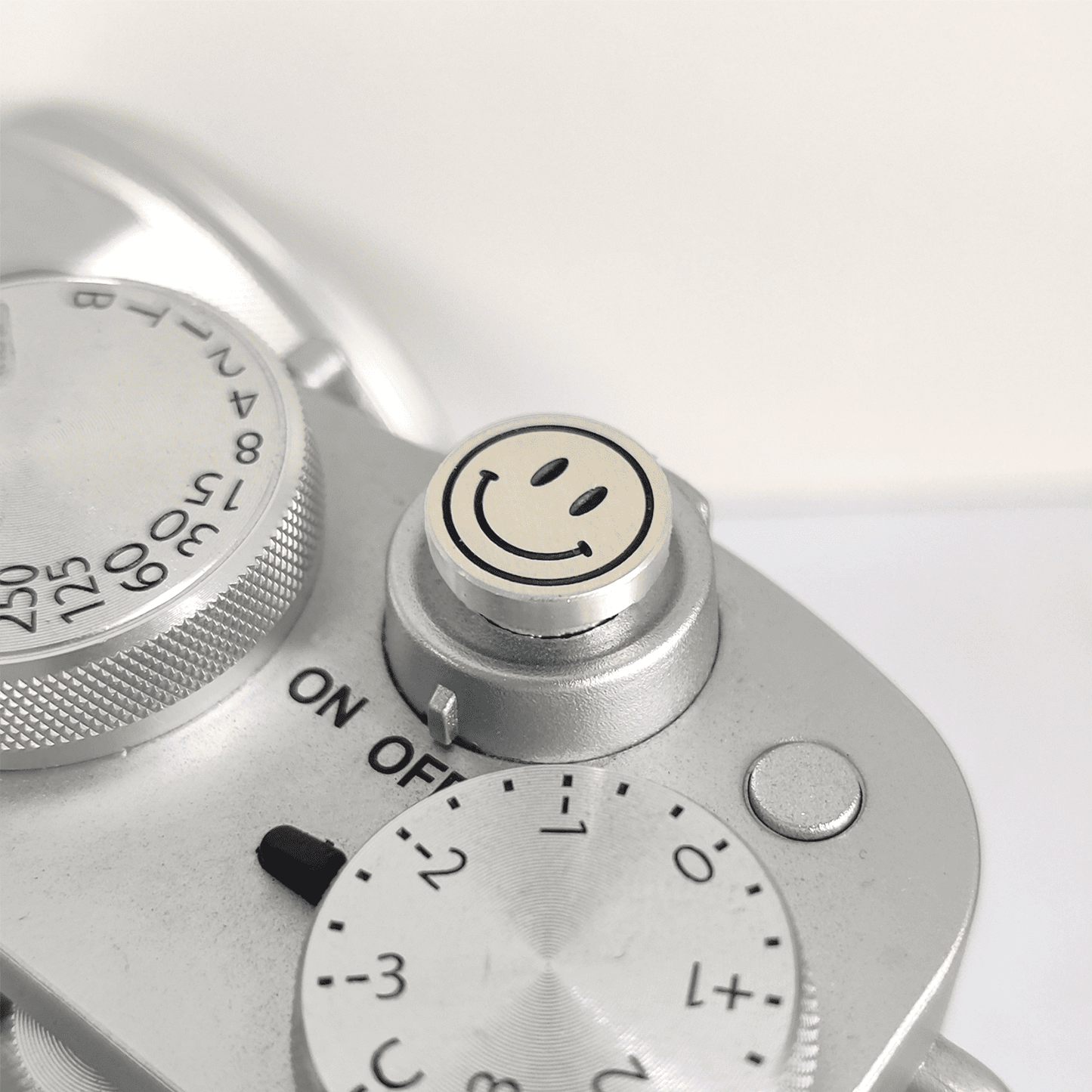 Engraved smile face camera button in silver