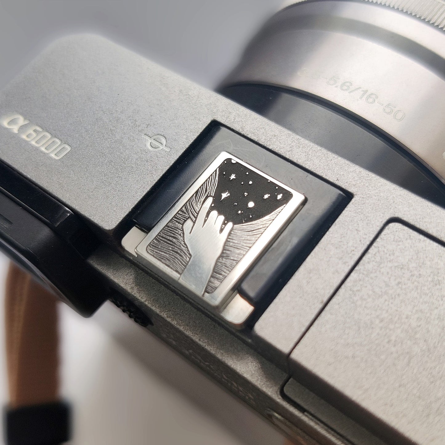 Reaching for the Stars silever hot shoe cover on sony camera
