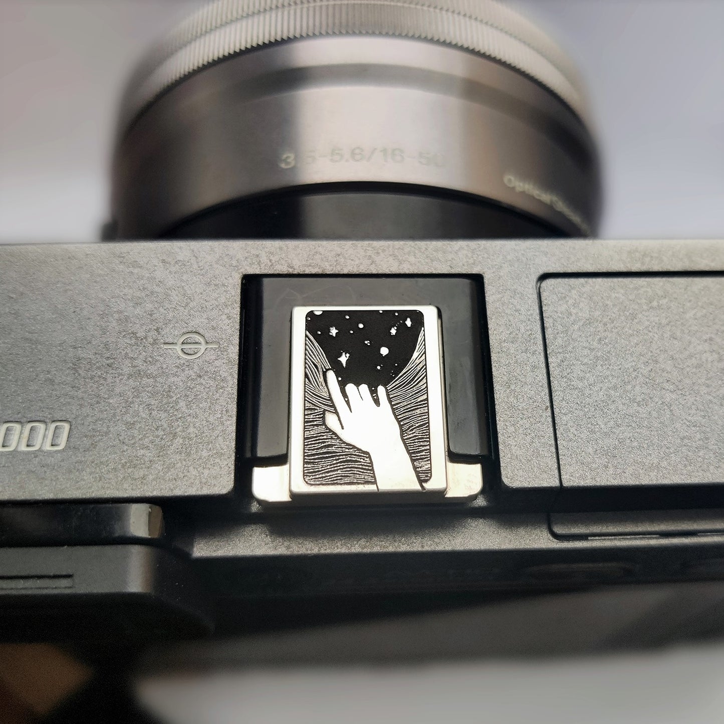 Reaching for the Stars camera brass hot shoe cover front view