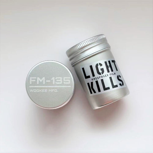 Two silver film containers labeled 'FM-13E' and 'LIGHT KILLS' on a white background.