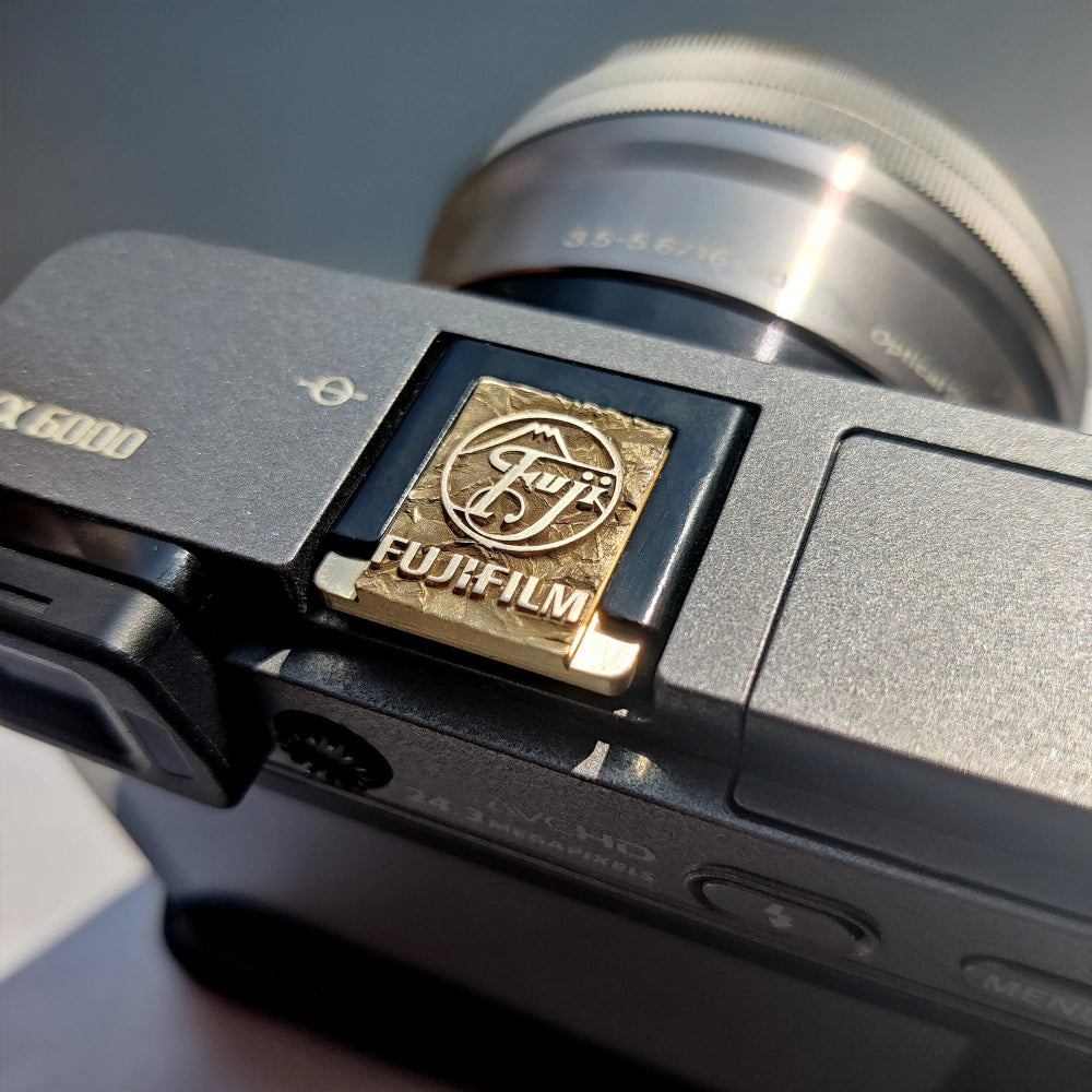 Greypeak gold hot shoe cover on Fujifilm camera