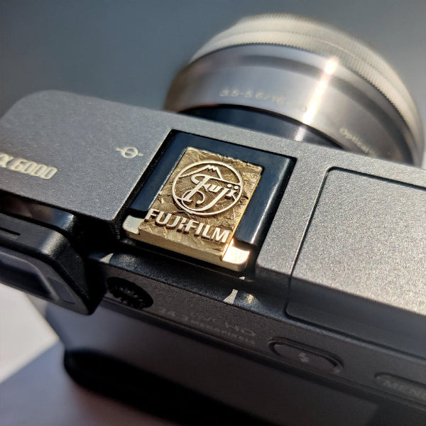 Greypeak gold hot shoe cover on Fujifilm camera