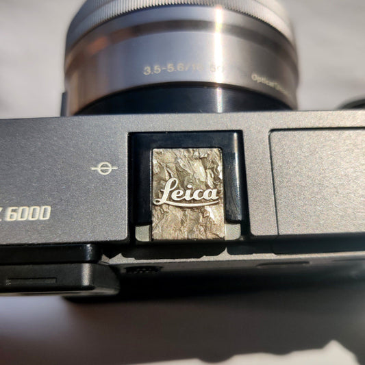 silver Leica M hot shoe cover with engraved mountain design