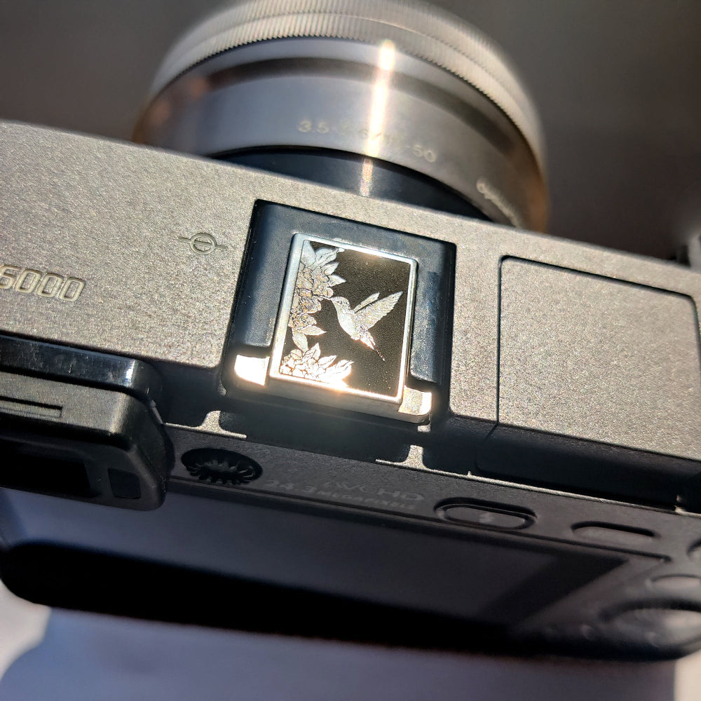 Leica M11 silver hot shoe cover with hummingbird flower design
