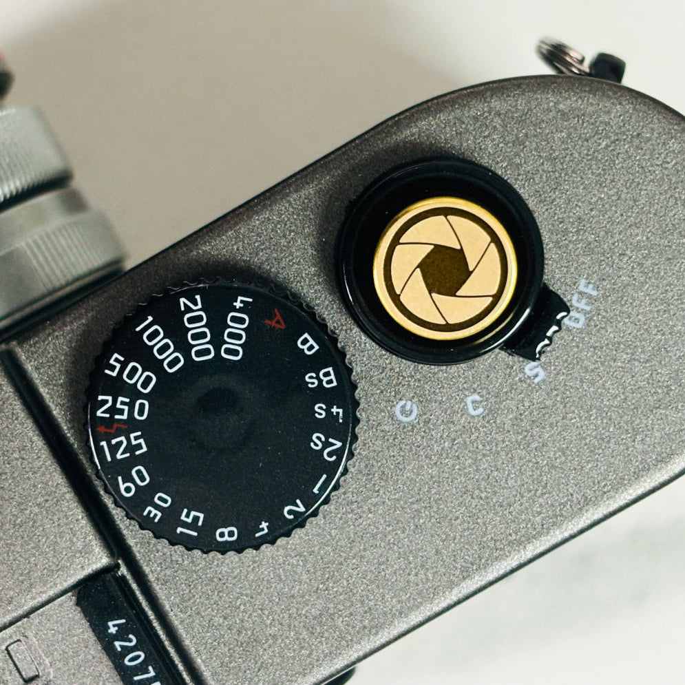 Lens Master gold shutter button mounted on Fujifilm camera