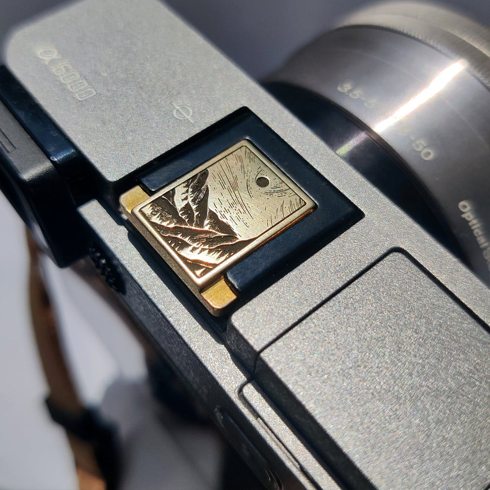 minimalist gold camera accessory – mountain stream design