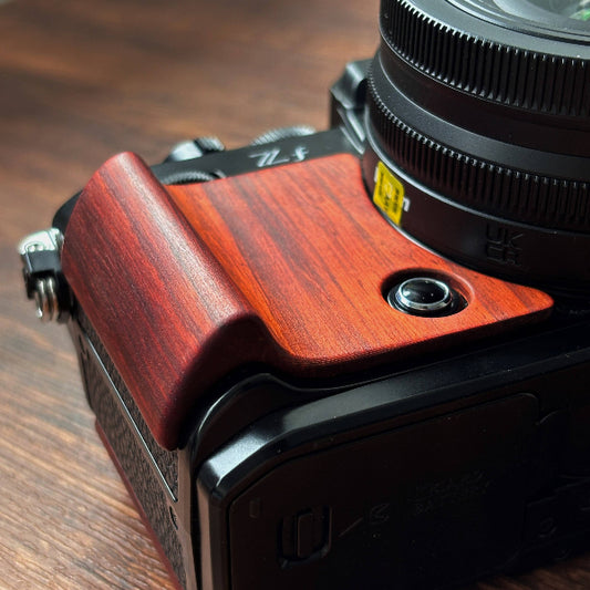 Nikon ZF camera with wooden grip on a wooden surface