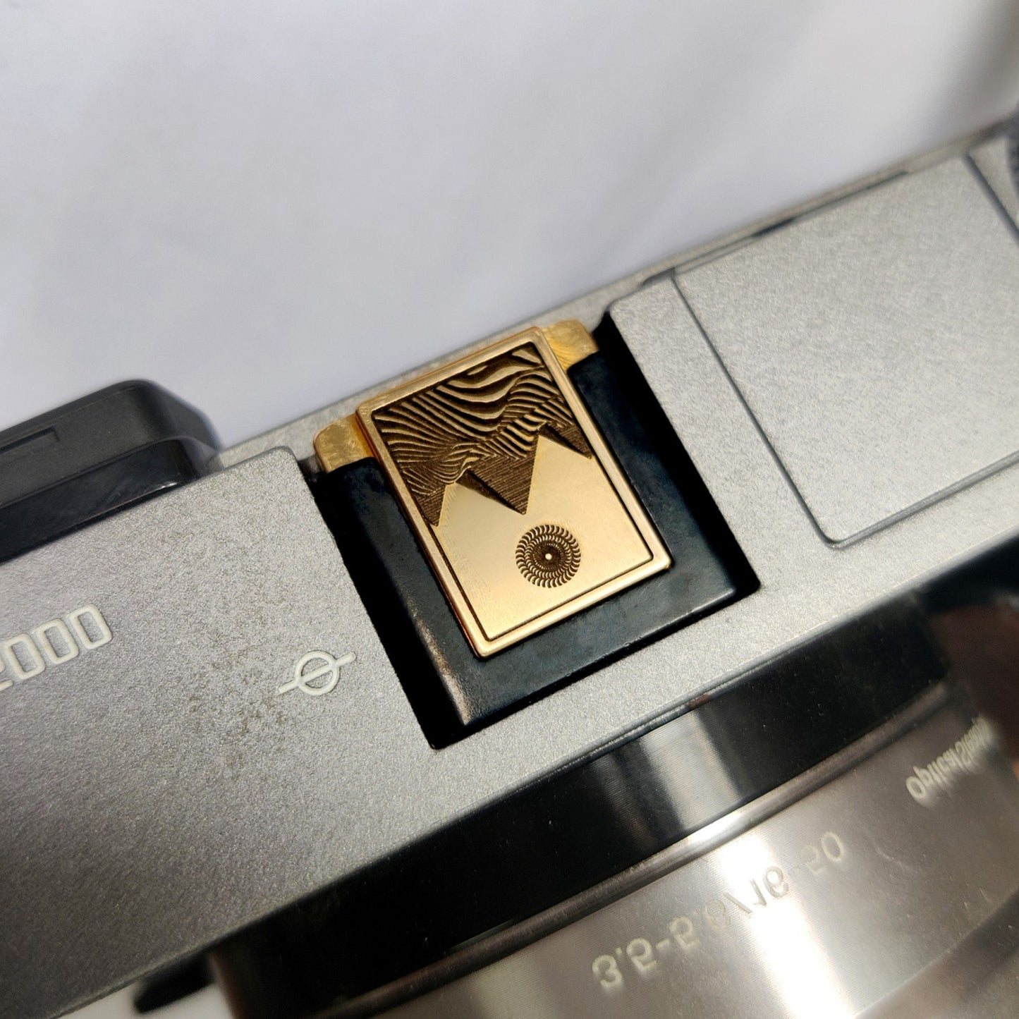 premium gold engraved camera hot shoe cover on camera