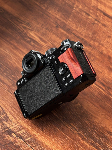 NIKON ZF Camera with wooden camera grip on a wooden surface