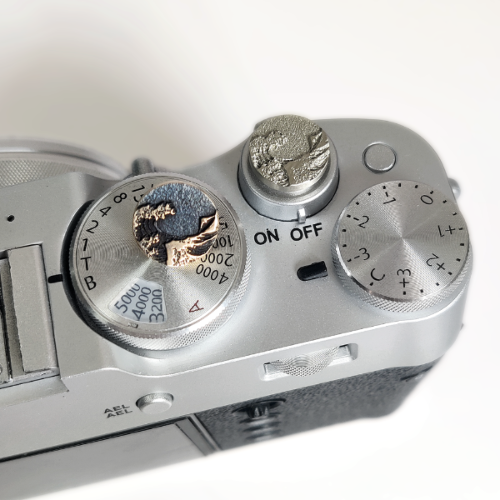 metal camera shutter button with ocean wave design