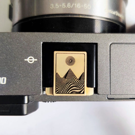 Close-up of a camera pyramid hot shoe cover on sony camera