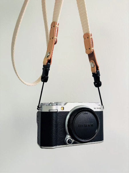 white canvas top leather camera strap on fuji camera
