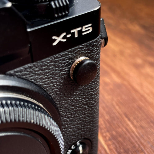 black wood flash remote pc sync terminal cap cover on a black Fujifilm X-T5 camera