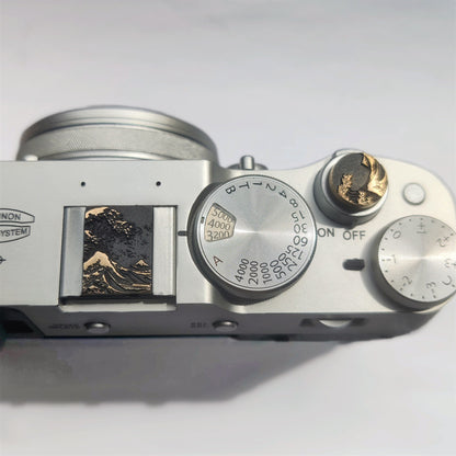 Gold ocean wave camera hot shoe cover mounted and shutter button on Fujifilm X100