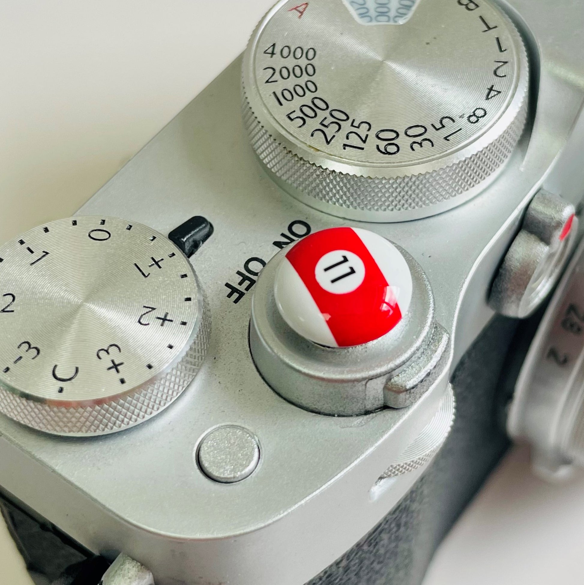 Close-up of a camera control panel with billiards soft release button red 11