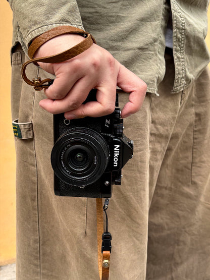 bison embossed leather texture slim camera strap on wrist