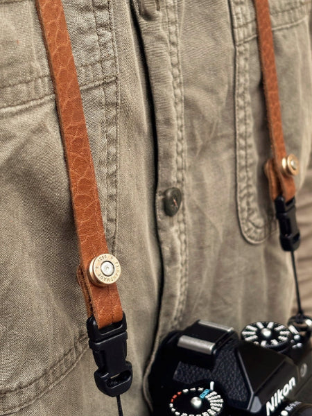 Close-up of bison embossed leather texture strap with bullet buckle lock and quick-release hardware