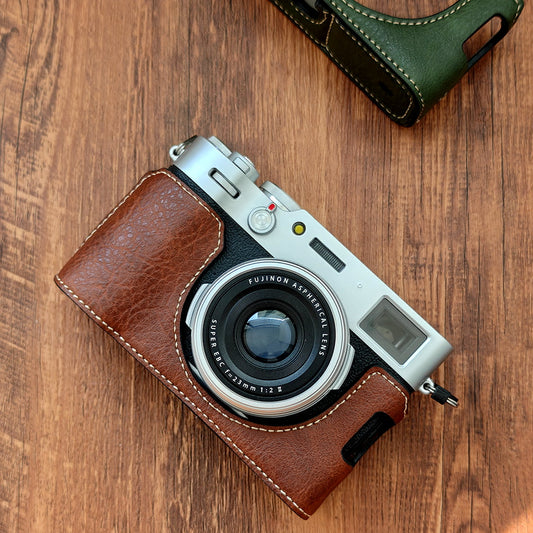 Fujifilm X100vi camera with a brown leather case on a wooden surface