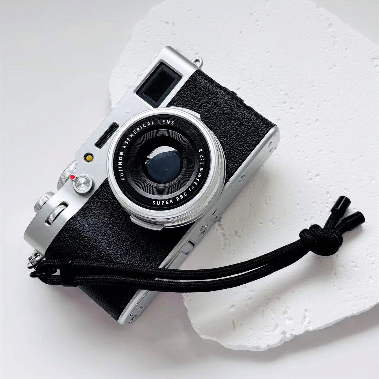 Vintage camera with a strap on a white background