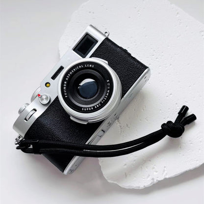 Vintage camera with a strap on a white background