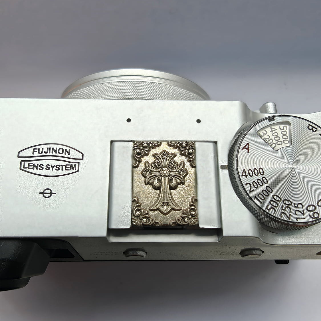 Close-up of a vintage camera hot sheo cover on a Fujifilm camera