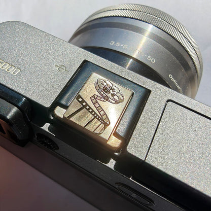 brass hot shoe cover with film design – left angle