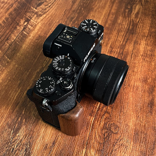 Fujifilm X-5 Camera with wooden grip on a wooden surface