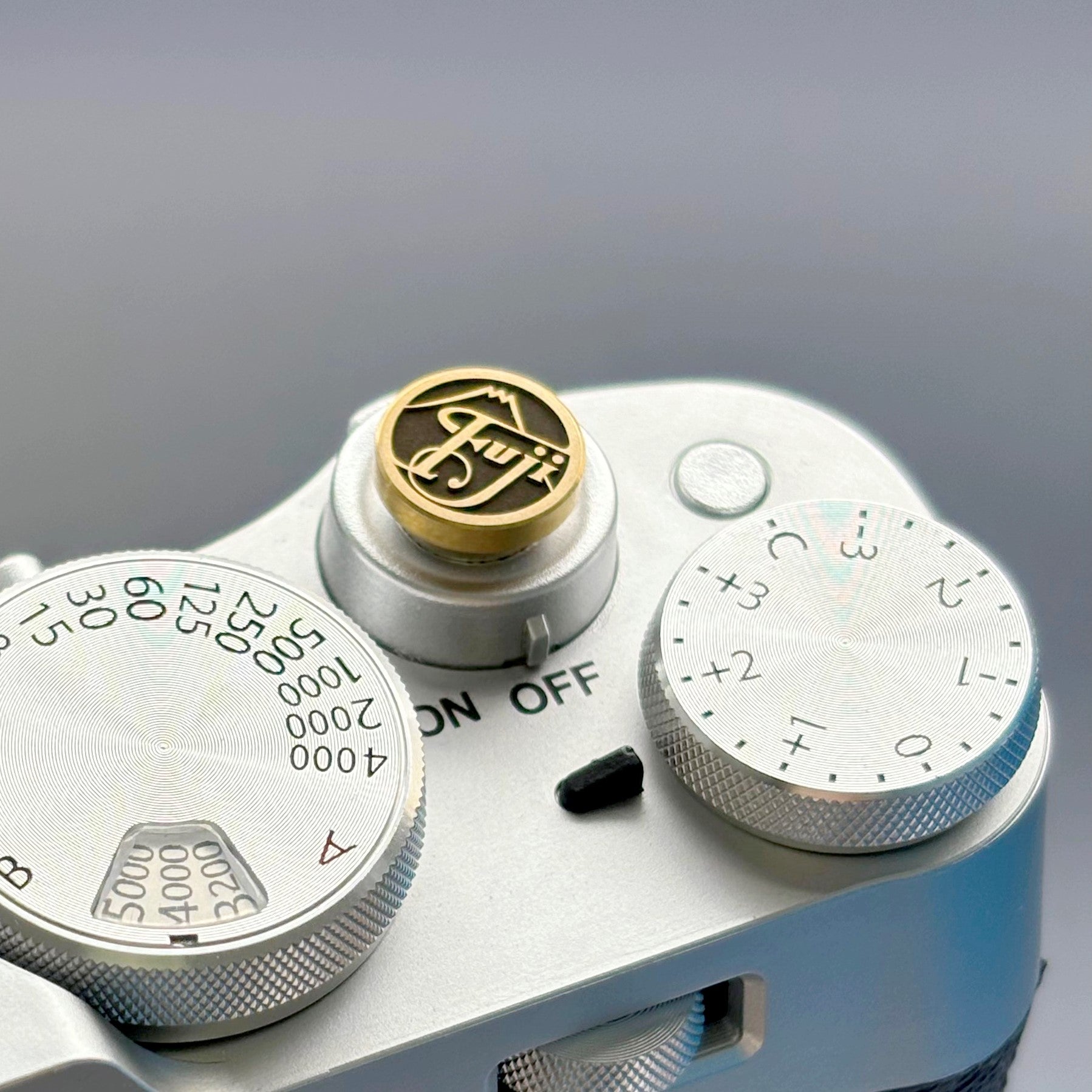 Close-up of a camera with a brand logo on a gray background