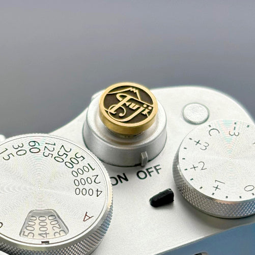 Close-up of a camera with a brand logo on a gray background