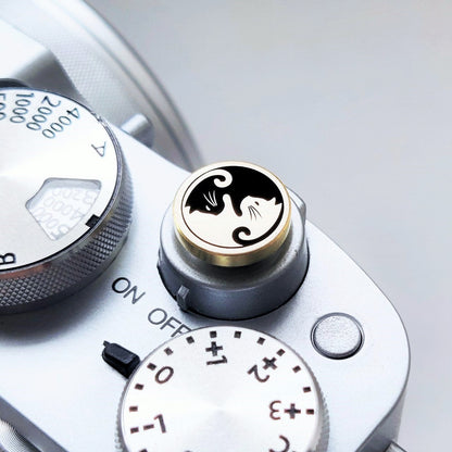 cat design brass shutter button close up detail