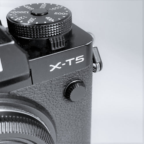 black aluminum flash remote pc sync terminal cap cover on a black Fujifilm X-T5 camera