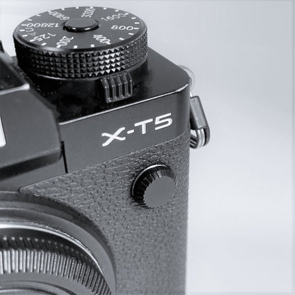 black aluminum flash remote pc sync terminal cap cover on a black Fujifilm X-T5 camera
