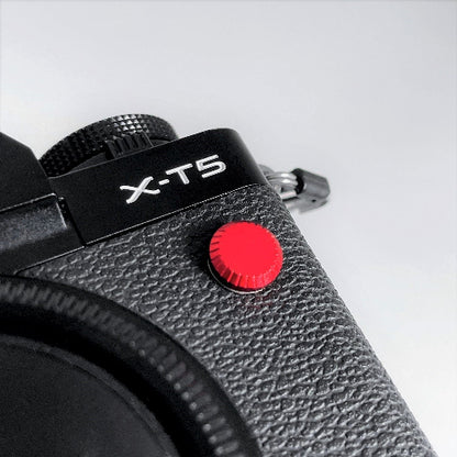 red metal flash remote pc sync terminal cap cover on a black Fujifilm X-T5 camera