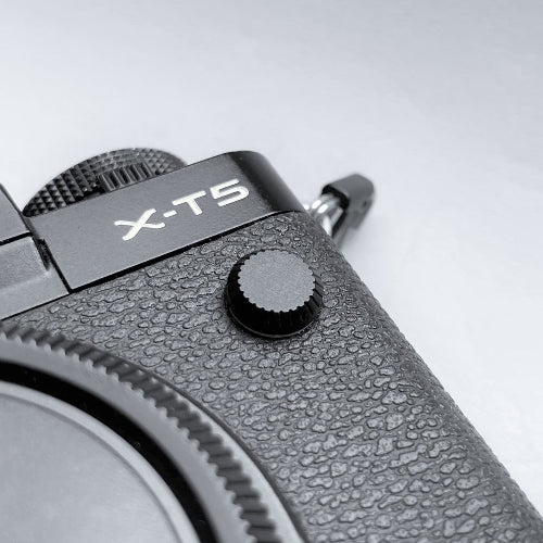 black flash remote pc sync terminal cap cover on a black Fujifilm X-T5 camera