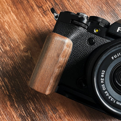 Close-up Fujifilm XT5 camera with a walnut wood L-shaped grip