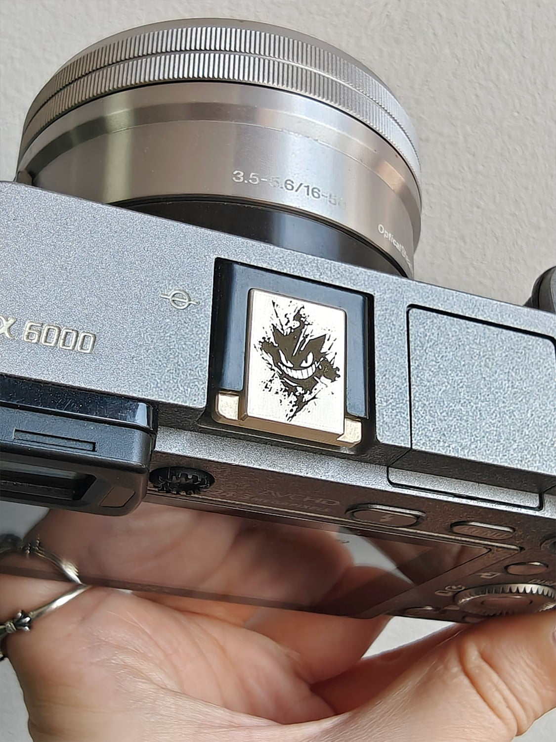 Sony camera with a gengar engraved hot shoe cover