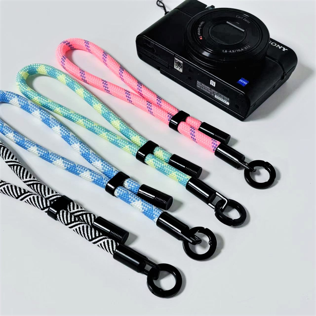 Camera with colorful wrist straps on a light gray background