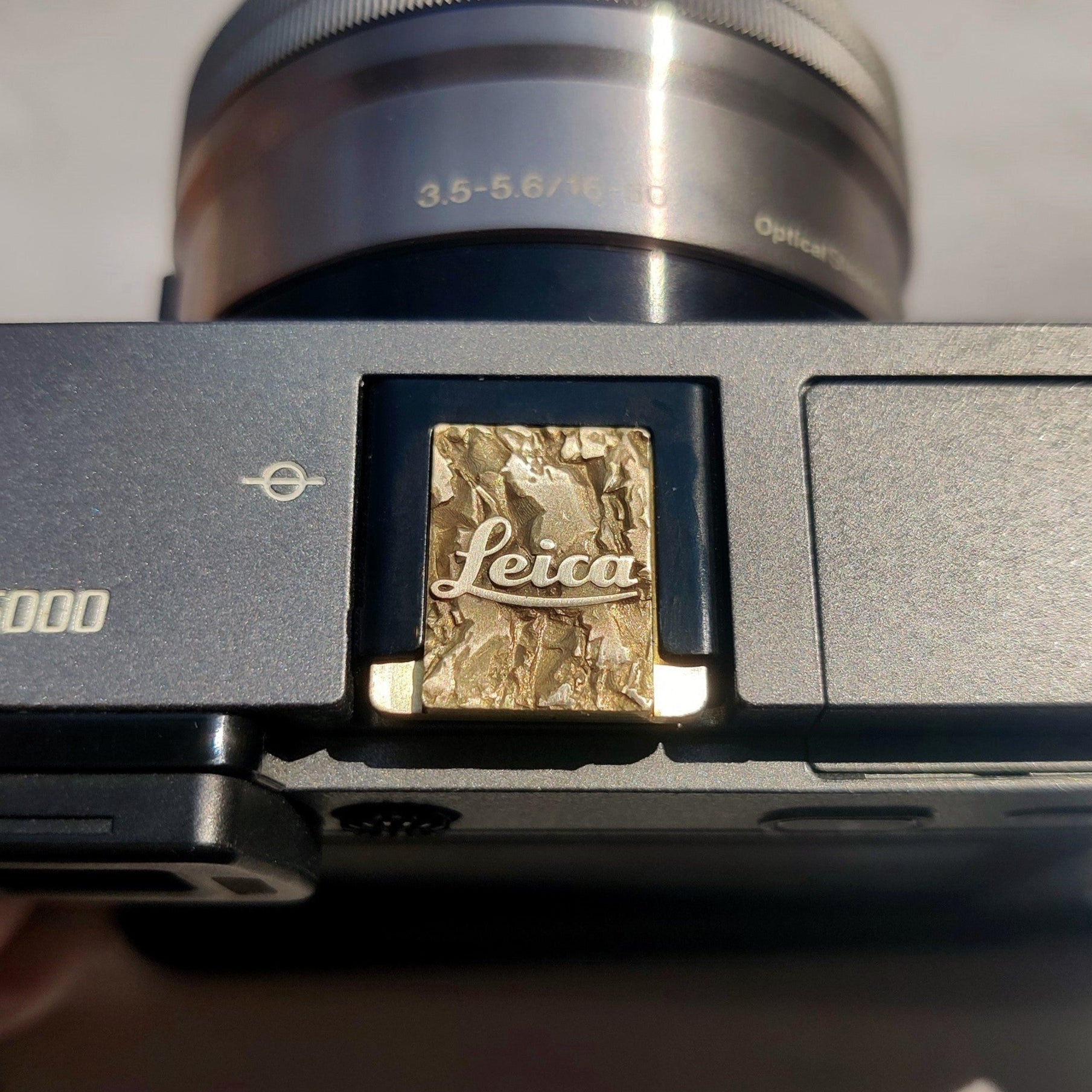 gold Leica M hot shoe cover with engraved mountain texture