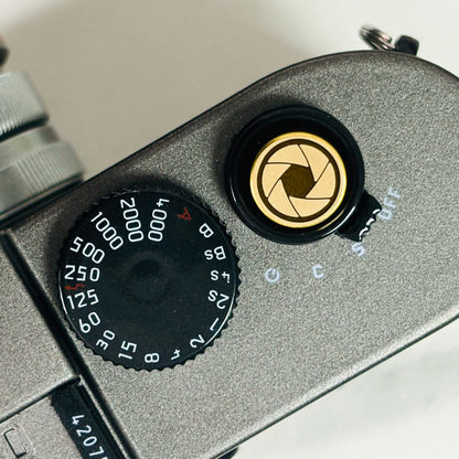 Lens Master gold shutter button mounted on Fujifilm camera