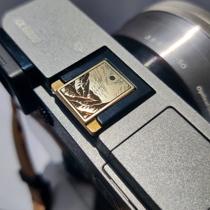minimalist gold camera accessory – mountain stream design