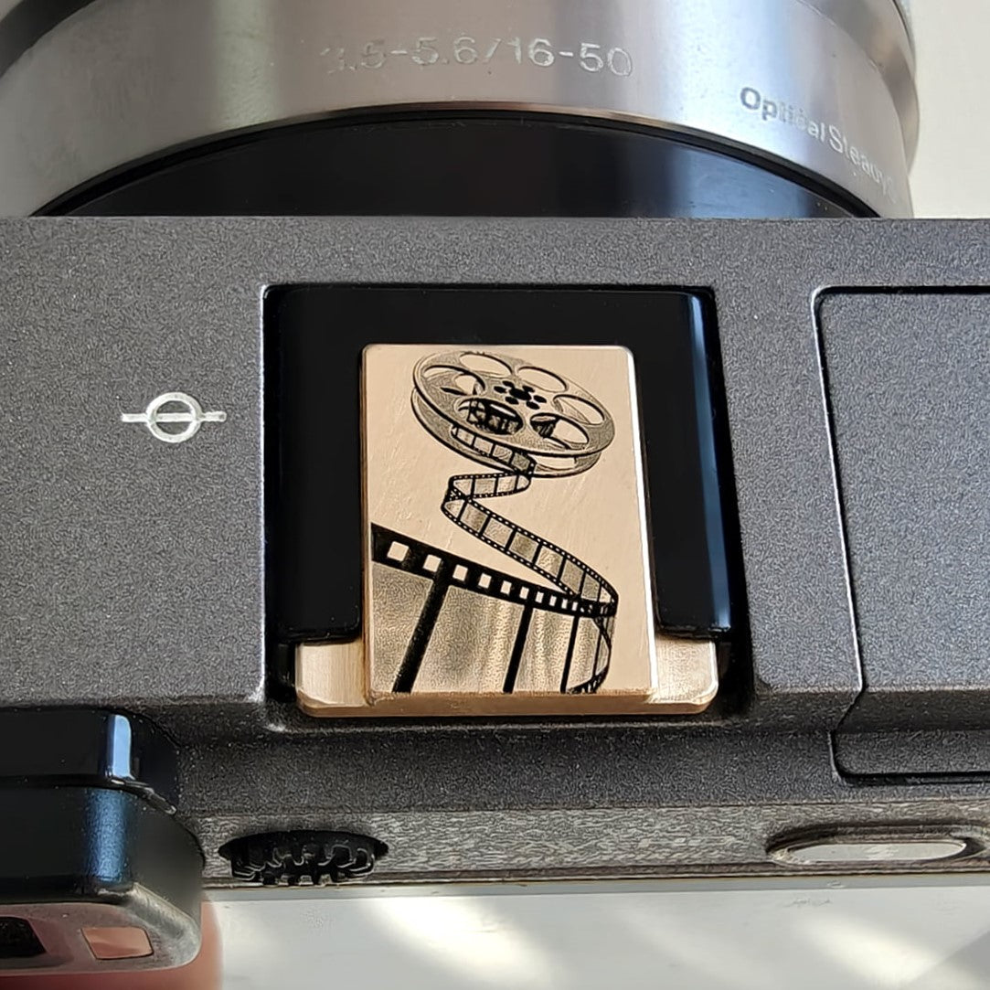 Vintage film roll brass hot shoe cover for Nikon FE2 – front view
