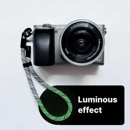 Sony camera with a strap on a white background, featuring a 'Luminous effect' label.