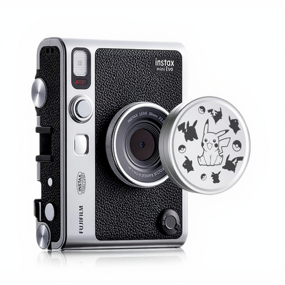 A Fujifilm Instax Mini EVO camera with a lens cap featuring a Pikachu design.