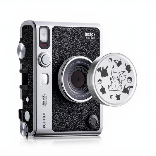 A Fujifilm Instax Mini EVO camera with a lens cap featuring a Pikachu design.