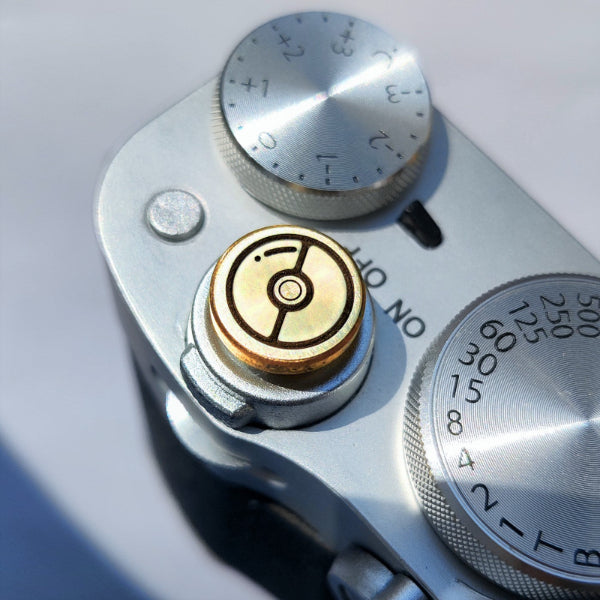 brass shutter button with pokeball design