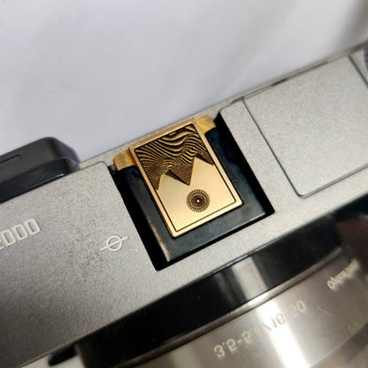 premium gold engraved camera hot shoe cover on camera