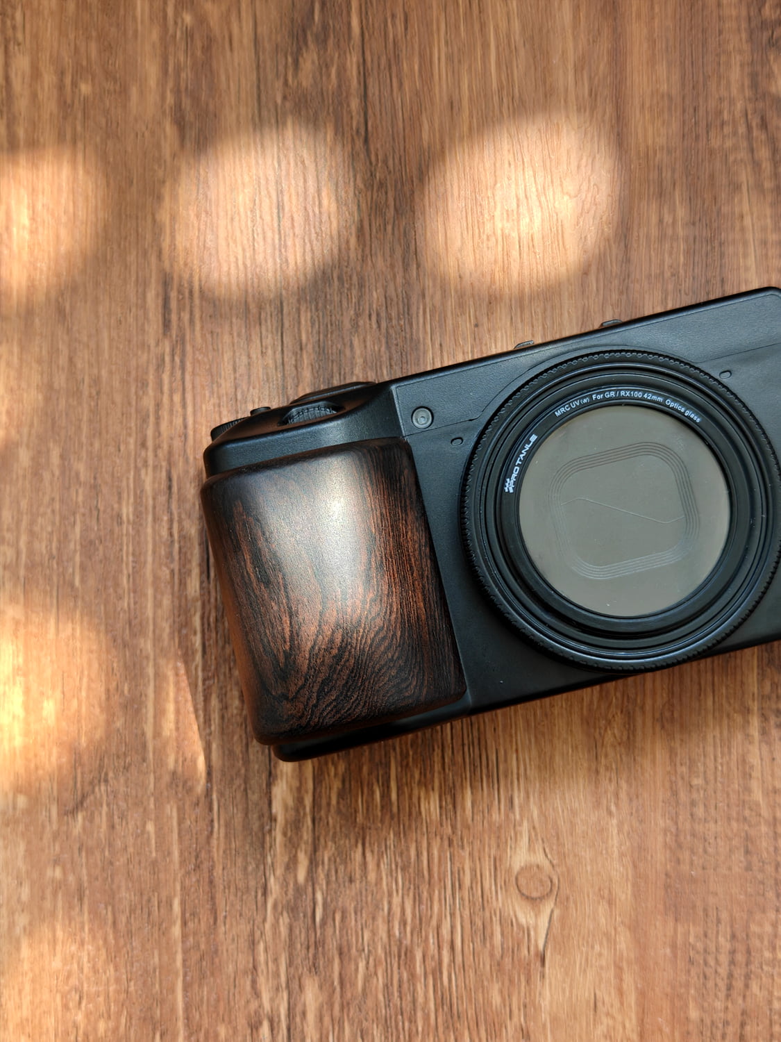 Dark ebony wooden grip on Ricoh GR III camera 